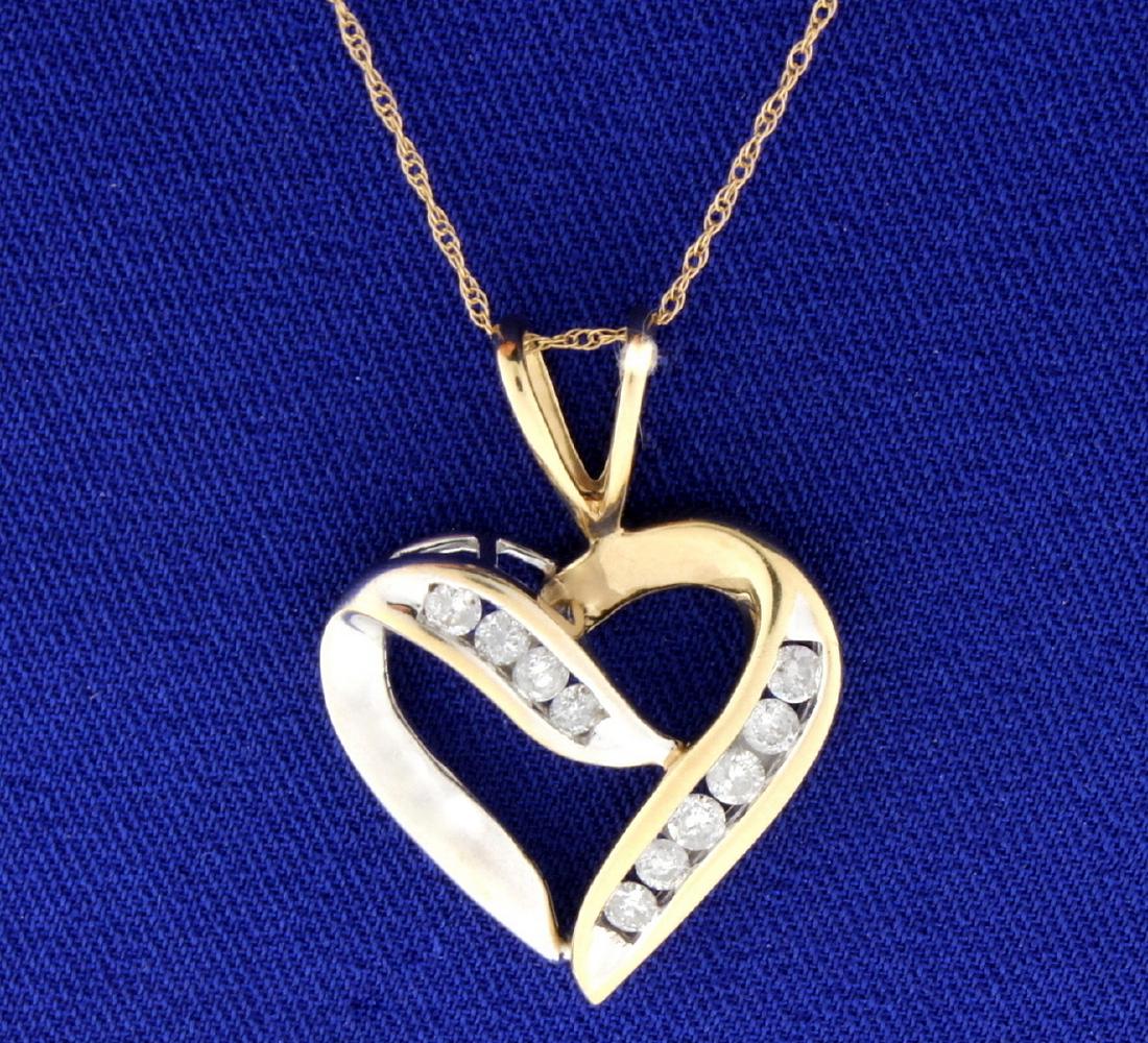 1/2 ct TW Diamond Heart Pendant with Chain: In 10k Yellow and White gold. Contains 1/2 ct TW of high quality brilliant cut diamonds, I color/I clarity. Pendant is 1/18 inches long, left side of pendant is white gold, right side is yellow gold.