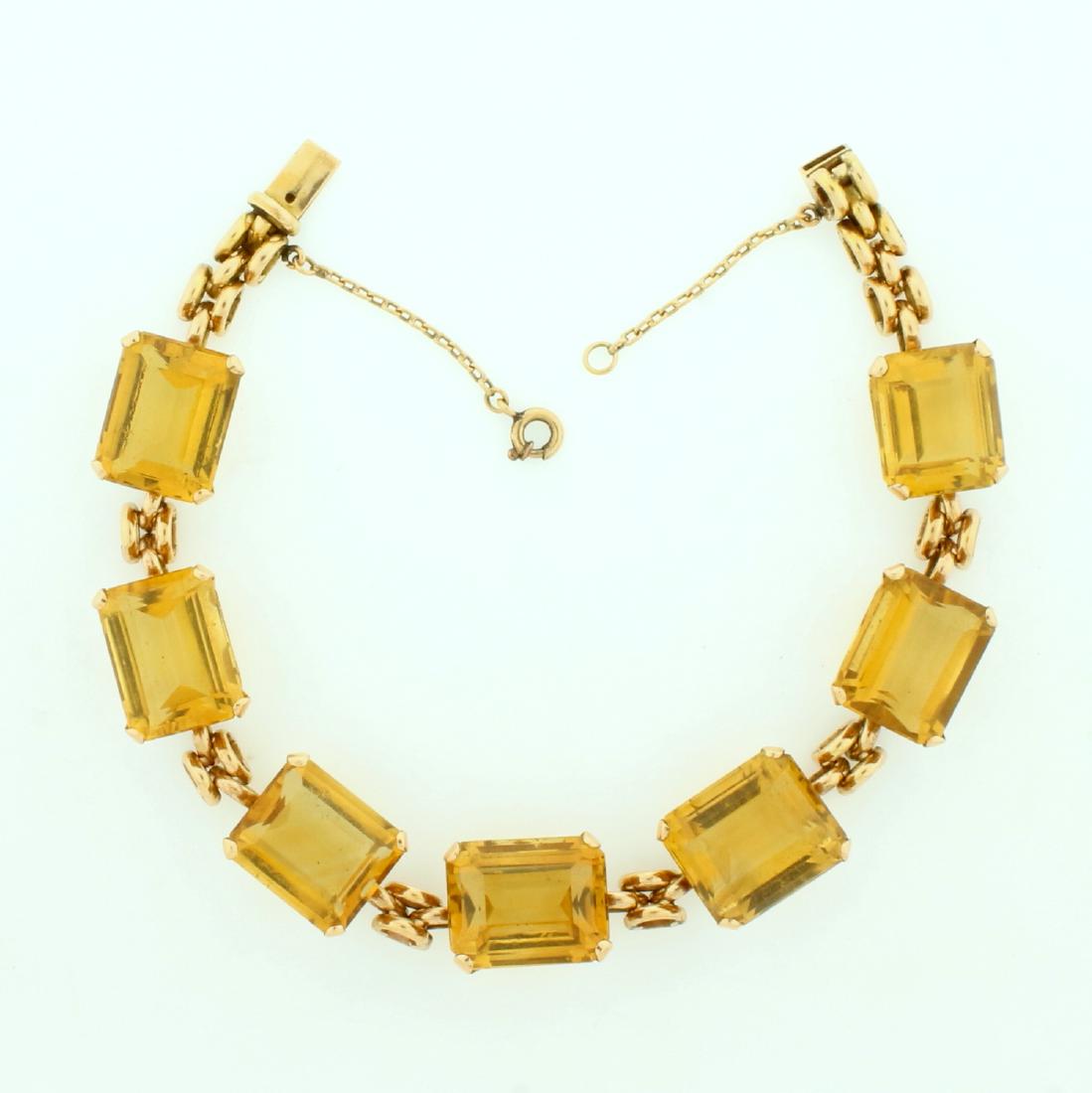 42ct TW Citrine Bracelet in 18k Rose Gold: In 18K rose gold. Contains seven 14x10mm emerald cut citrine gemstones with vibrant yellow color and excellent clarity-42ct total weight. The bracelet is 7 inches long and has a safety chain. 27.1g