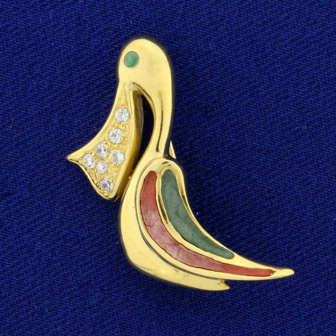 Enameled Pelican Pin with Diamonds in 14K Yellow Gold: In 14K Yellow Gold. Contains seven round high quality .01ct Diamonds, VS clarity/G color. Green enamel eye, with pink and green enamel detail on wing. Minor crack in red enamel on bird per picture. 1 