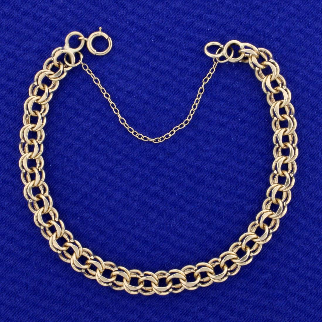 Double Loop Link Charm Bracelet in 14k Yellow Gold: In 14K Yellow Gold. 7 1/2 inches long, with safety chain. 7mm wide. 11.9g.