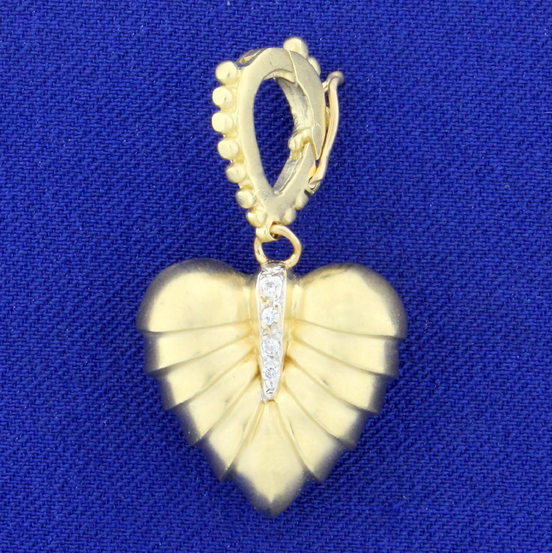 Vintage Solid Gold and Diamond Heart Pendant in 14K: In 14K Yellow Gold. 1 3/8 inches long with openable bale. Contains ten high quality 1/2pt round diamonds. 9.3g.