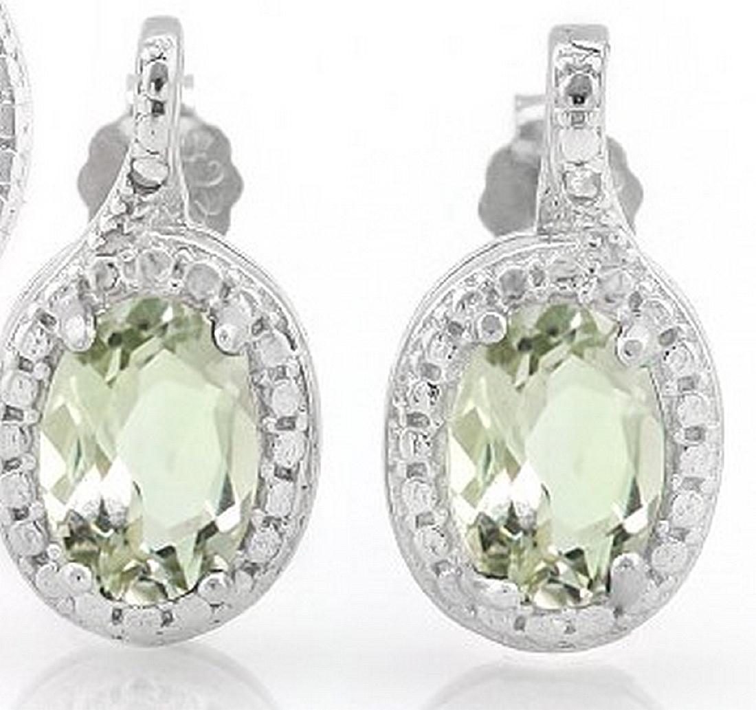 Green Amethyst and Diamond Earrings in Sterling Silver: Contains 2-5x7mm oval cut Green Amethyst gemstones with excellent clarity and green tea color accented with .01ctw genuine diamonds. Measures 9/16" long, set in .925 sterling silver with friction back