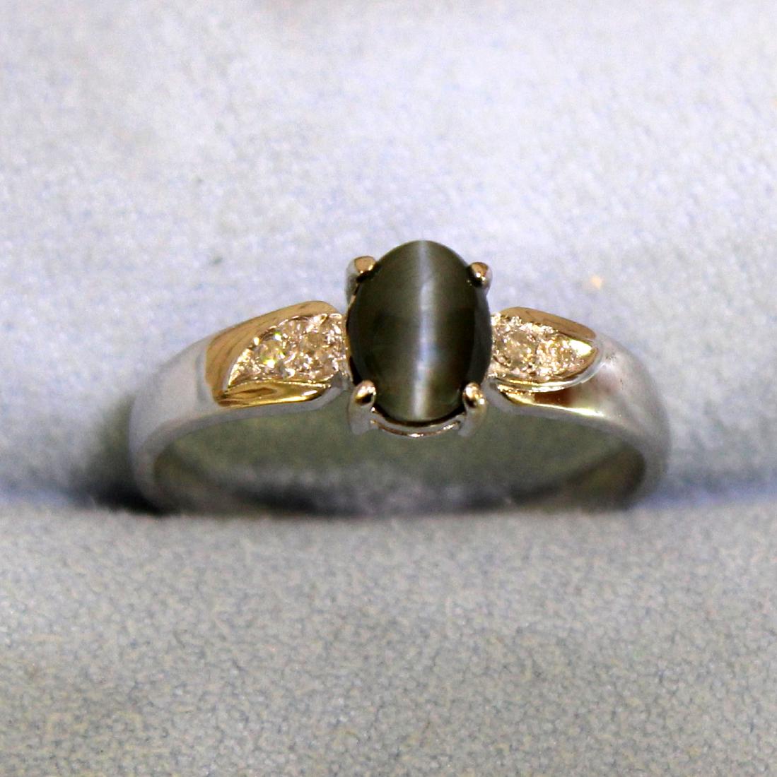 Natural Cats Eye and Diamond Ring in 14K White Gold: In 14K White Gold. Contains a natural 7x5mm oval Cats Eye with grey/green color and very distinctive cats eye. Also contains four high quality .01ct round Diamonds, VS clarity/H color. Size 8. 2.1g