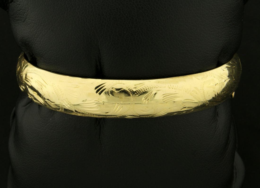 Etched Bangle Bracelet with Floral Design in K Yellow: In 14K Yellow Gold. 2 1/4 x 2 inches inside diameter. Hinges open/close, with safety chain. 14.3g