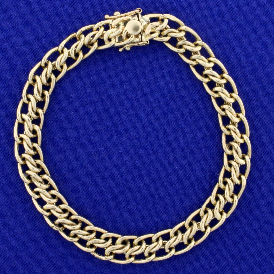 7 3/4 Inch Tiffany Stamped 7.5mm Double Row Link: In 14k Yellow Gold. 7.5mm wide, 7 3/4 inches long. Stamped "Tiffany". Double safety clasp. 12.2g.