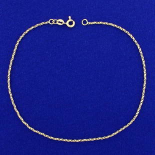 10 Inch Twisting Box Link Anklet in 14K Yellow Gold: In 14K Yellow Gold. 10 inches long with spring clasp. 1.4mm wide. 2.3g