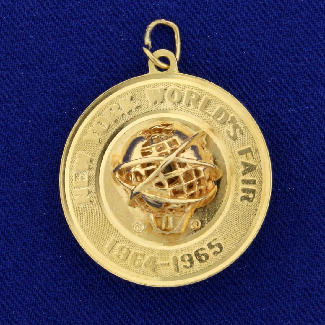 Collectible Antique 1964 New York World's Fair Pendant: In 14K Yellow Gold. "New York World's Fair 1964-1965" 1 1/4 inches long with bale. 6.5g