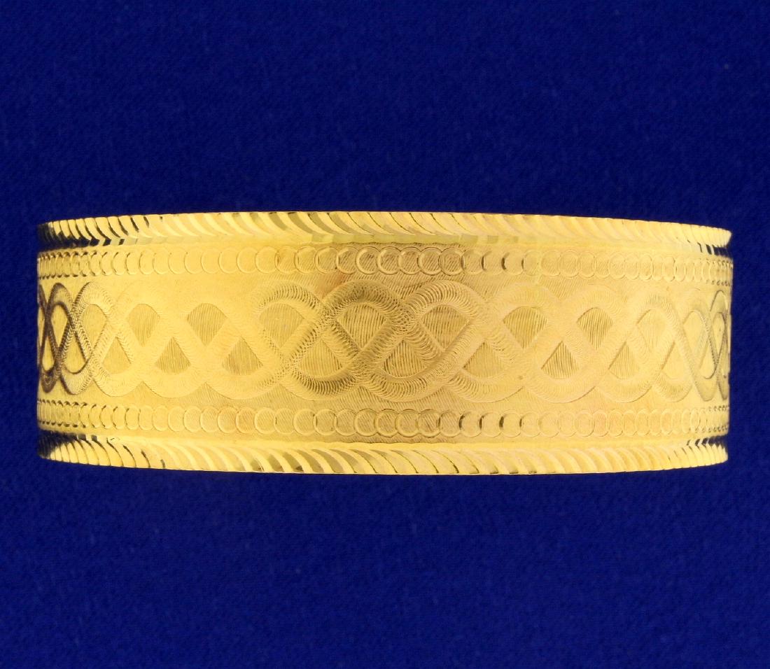 Dubai Made Wide Bangle Bracelet in 22k Yellow Gold: In 22k yellow gold, 2 3/8 inch diameter and 20mm wide. Unique etched design. 37.5g.