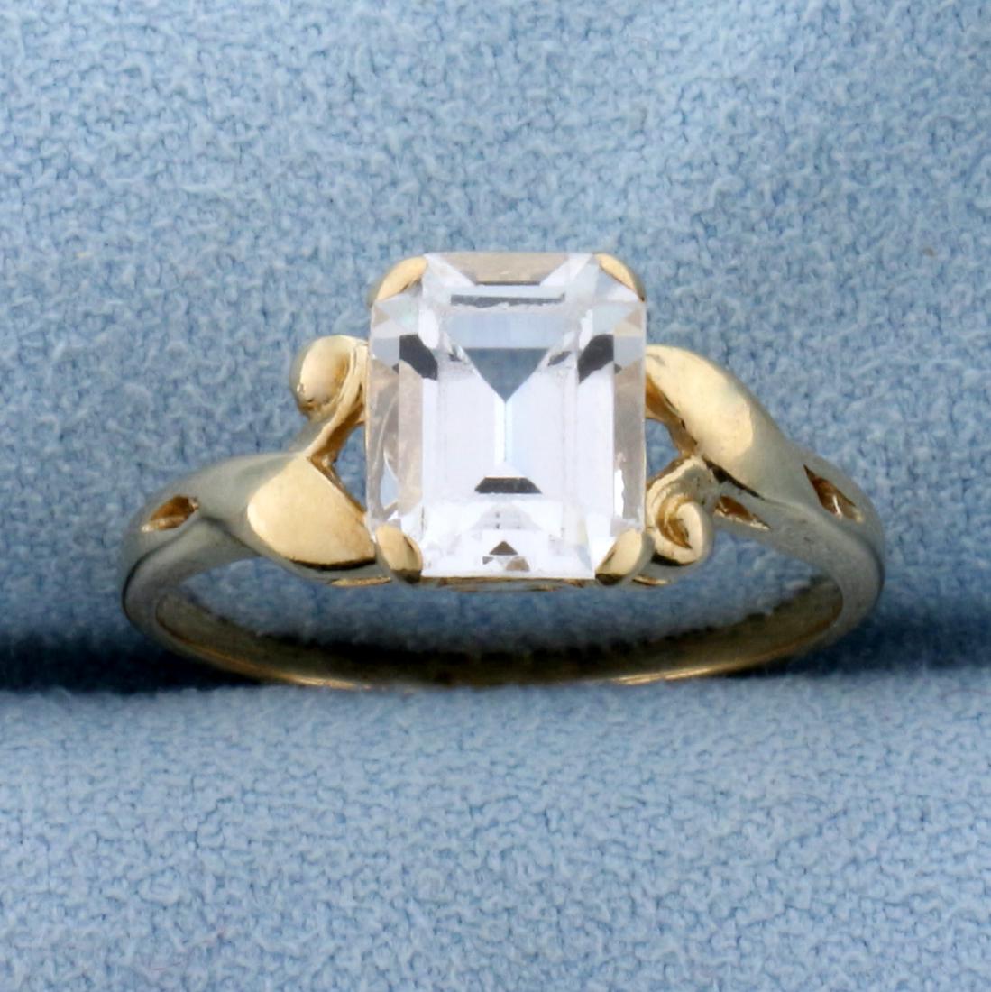 1.5ct White Sapphire Solitaire Ring in 14K Yellow Gold: In 14K Yellow Gold. Contains a high quality natural 8x6mm emerald cut White Sapphire gemstone with excellent clarity and color. Size 7. 2.2g