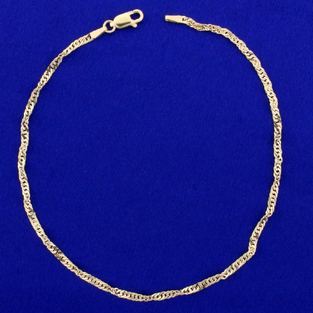 Twisting Curb Link Anklet in 14K Yellow Gold: In 14K Yellow Gold. 10 inches long, 2.3mm wide. Lobster clasp. 2.5g.