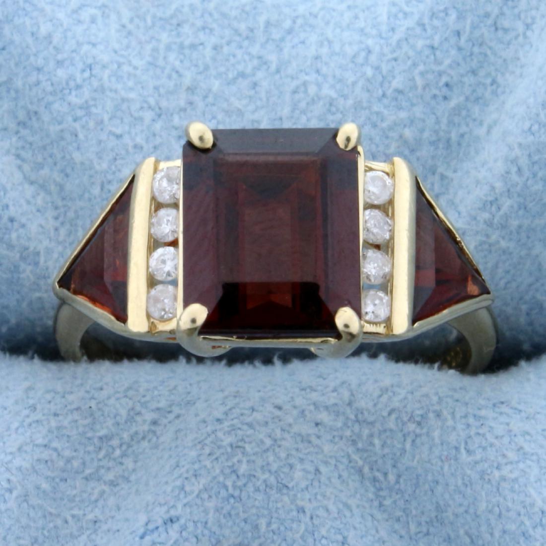 5ct TW Garnet and Diamond Ring in 14K Yellow Gold: In 14K Yellow Gold. Contains one high quality natural 10 x 8mm emerald cut and two 7mm trillion cut Garnet gemstones with beautiful intense red color and excellent clarity. Also contains eight high qu