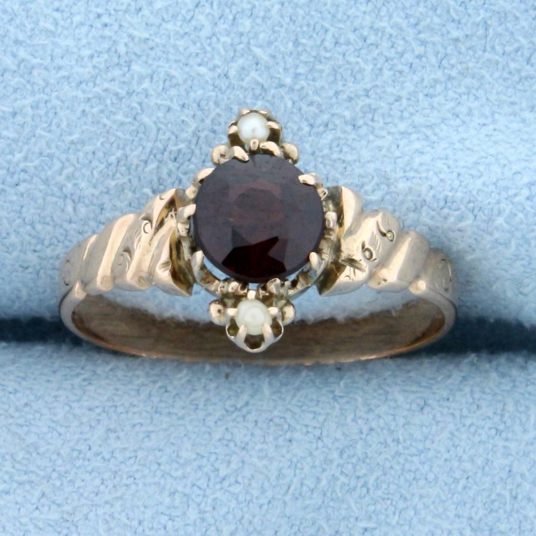 Antique 1ct Garnet and Pearl Ring in 14K Rose Gold: In 14K Rose Gold. Contains one high quality 1ct round cut Garnet gemstone with beautiful deep burgundy red color and excellent clarity. Also contains two 1.5mm seed Pearls. Size 6 1/2. 2.0g.