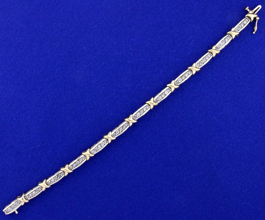 2ct TW Diamond Tennis Bracelet in 10k Gold: In 10k yellow and white gold. Contains 2cts of I clarity/I color diamonds. 7 1/4 inches long with safety clasp. 10.5g.