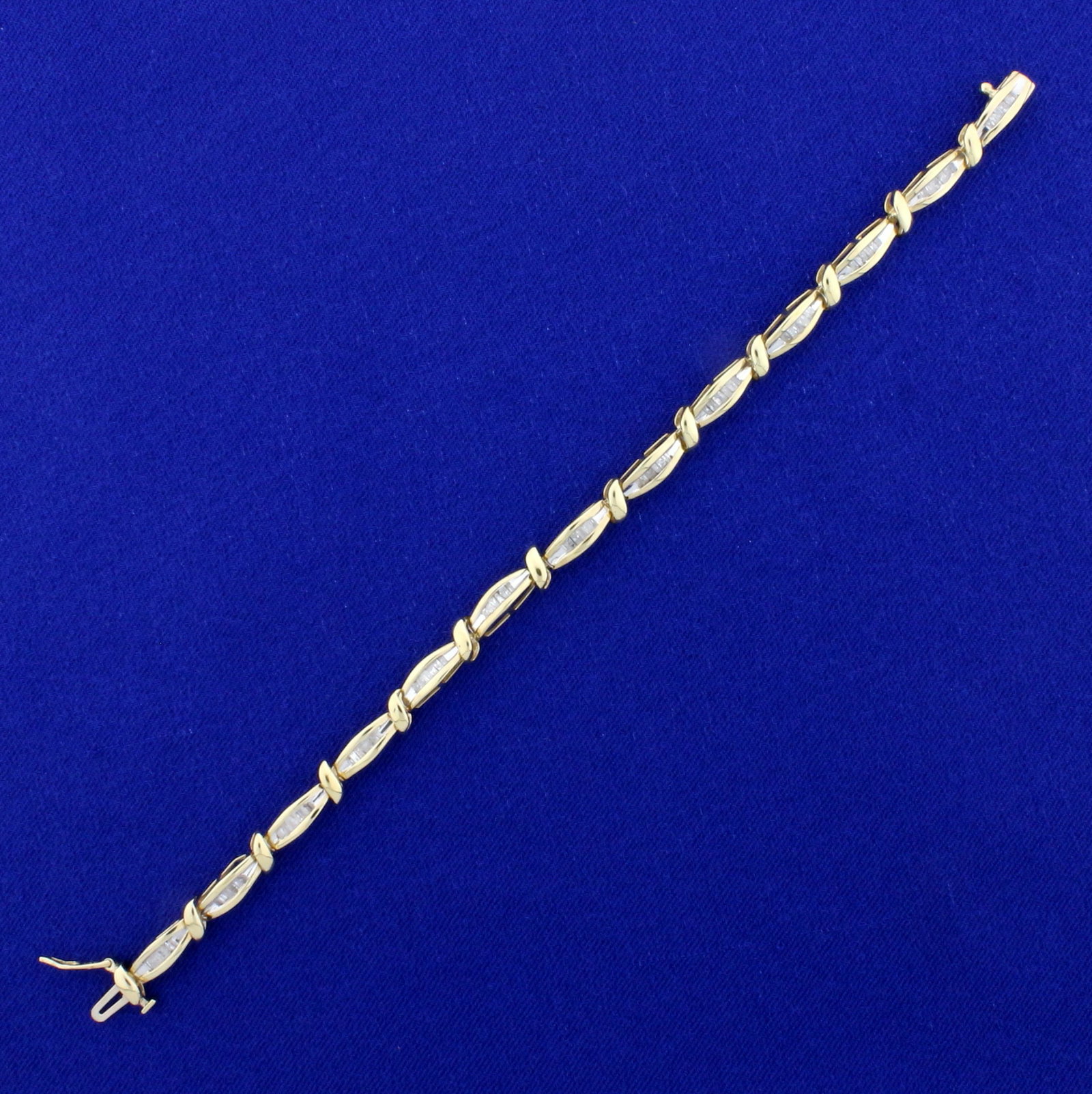 3/4ct TW Baguette Diamond Tennis Bracelet in 10K Yellow: In 10K Yellow Gold. Contains seventy-eight high quality .01ct baguette shaped Diamonds. 6 1/2 inches long and 3.9mm wide. 7.7g
