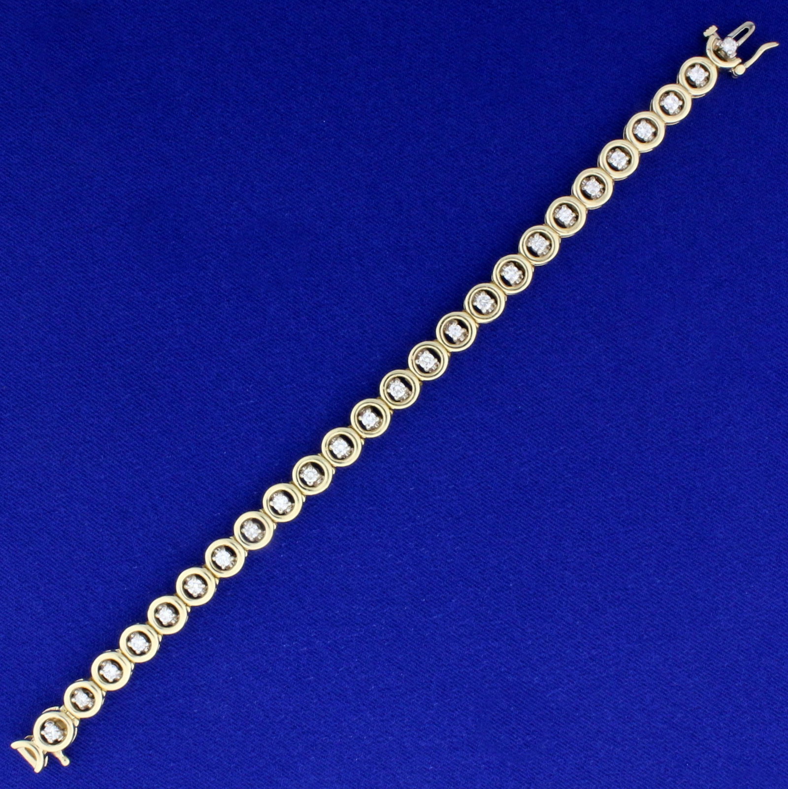 2ct TW Circle Link Tennis Line Bracelet in 14K Yellow: In 14K Yellow Gold. Contains 25 high quality round cut Diamonds, I color/ I1 clarity. 7 inches long, 7.1mm wide. Concealed clasp with safety latch. 21.6g.
