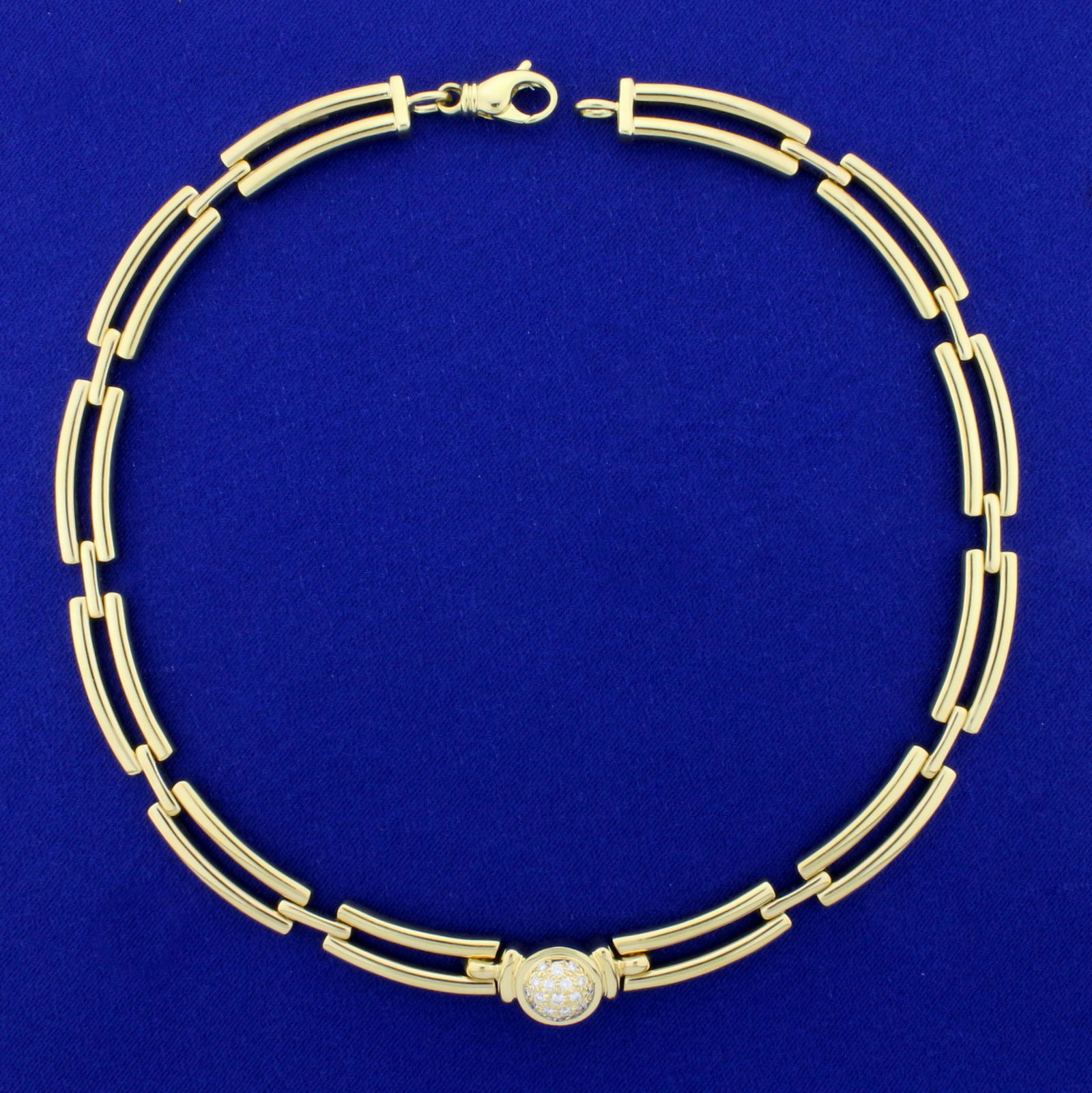 Movado Designer 1/2ct TW Diamond Choker Necklace in 18K: In 18K Yellow Gold. Contains nineteen high quality diamonds ranging from .02ct to .04cts each, VS clarity/G color. 16 inches long. Links are 8.8mm wide. Lobster clasp. 67.4g.