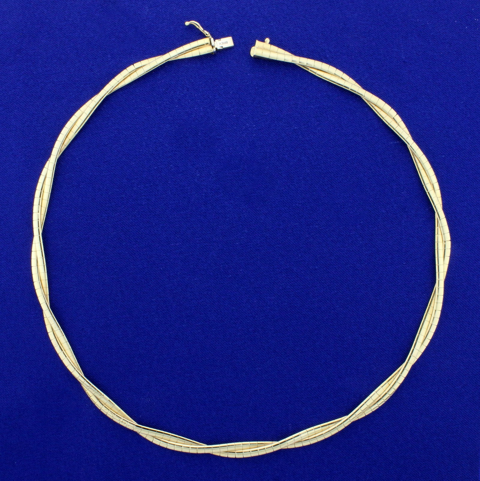 Italian-Made 16 1/2 Inch Braided Double Strand Omega: In 14K Yellow Gold. 16 1/2 inches long, 5.5mm wide. Safety Clasp. 25.7g.