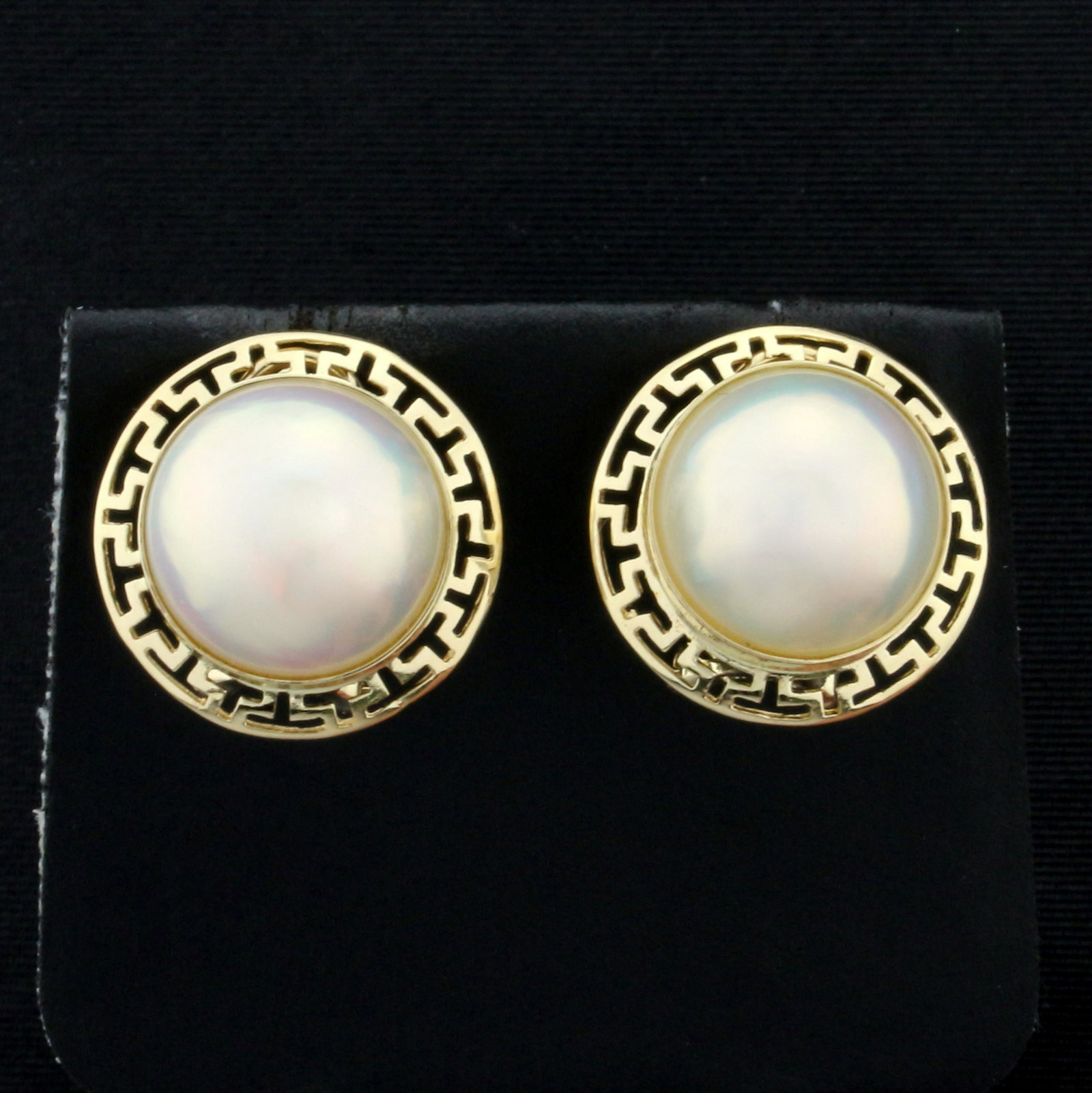 12mm South Sea Pearl Earrings in 14K Yellow Gold: In 14K Yellow Gold. Each earring contains a round South Sea 12mm Pearl with high luster and soft golden color. 3/4 inch long with omega backs. 5.8g