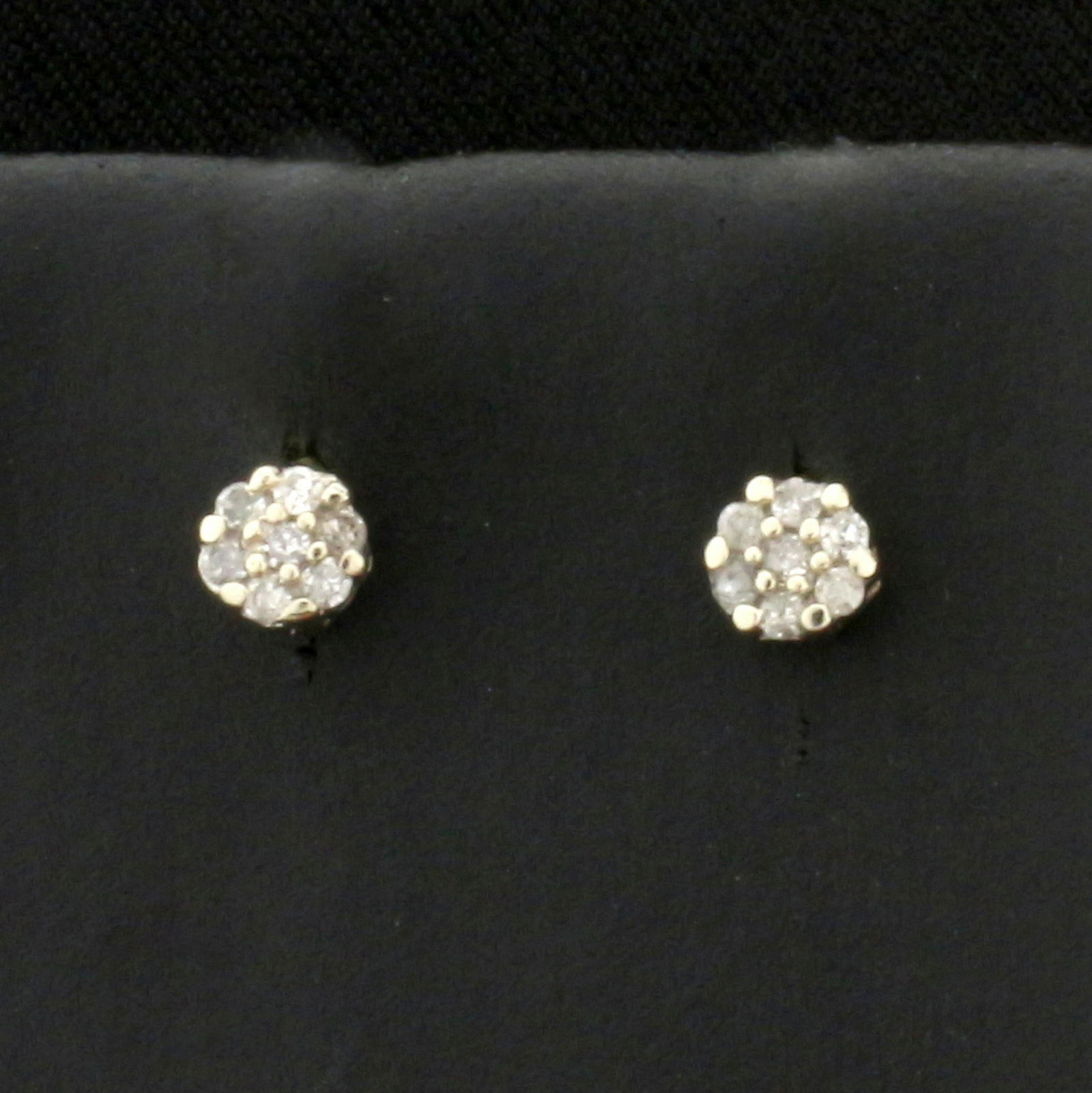 Diamond Cluster Earrings in 14K White Gold: In 14K White Gold. Each earring contains seven high quality 1/2pt diamonds, I color/I clarity. 0.4g.