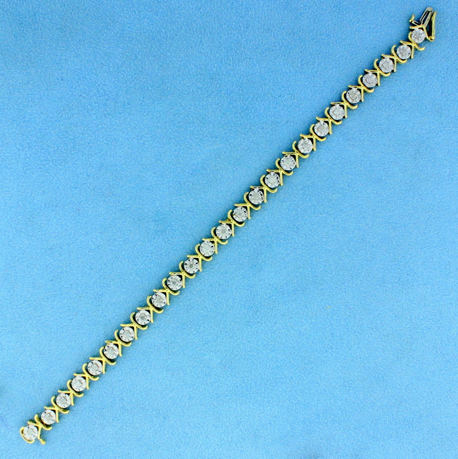 1ct TW Diamond Tennis Bracelet in 14K Yellow and White: In 14K Yellow and White Gold. Contains twenty-five high quality .04ct Diamonds, I color/I clarity. 7 1/4 inches long. 4.8mm wide. 8.4g.