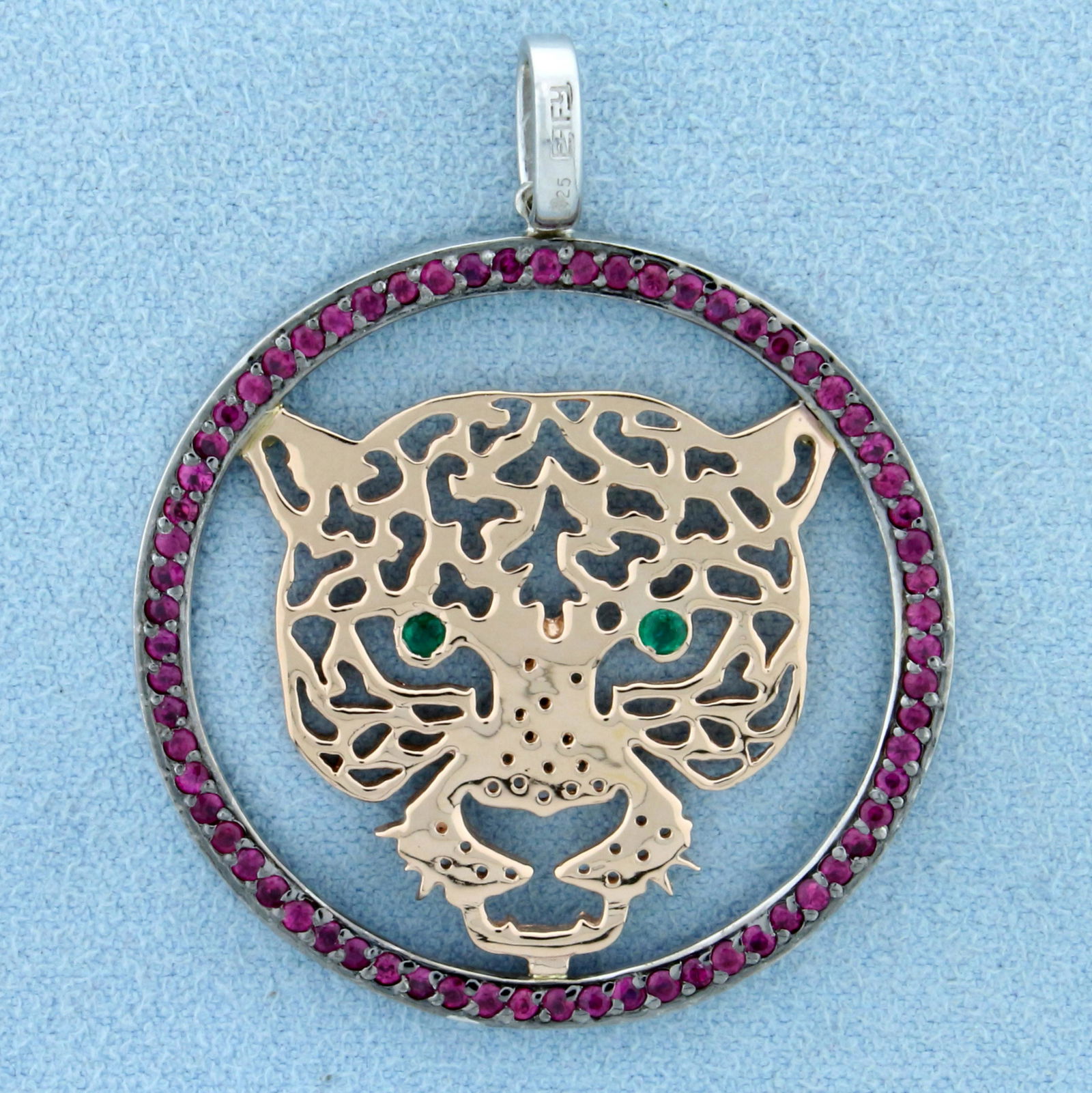 Effy Designer Tiger Pendant With Rubies and Emeralds in: In 14K Yellow and White Gold with Sterling Silver bail. 1 3/4 inches long , 1 3/8 inches diameter. Contains two high quality natural .02ct Emerald gemstones for eyes and sixty-seven high quality natur