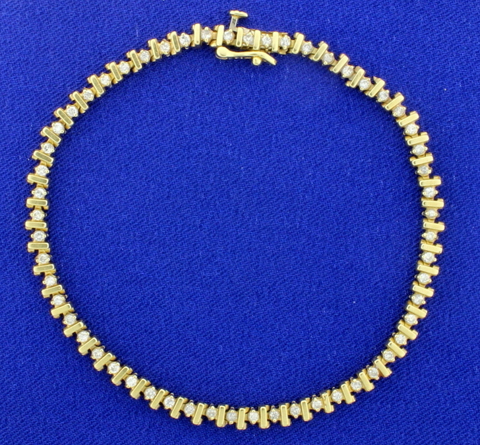 3/4ct TW Diamond Tennis Bracelet in 14k Yellow Gold: This bracelet is 14K yellow gold and is 7 1/2 inches long. It contains 3/4ct total weight of high quality diamonds, I color/I1 clarity. With safety clasp. 9.2g