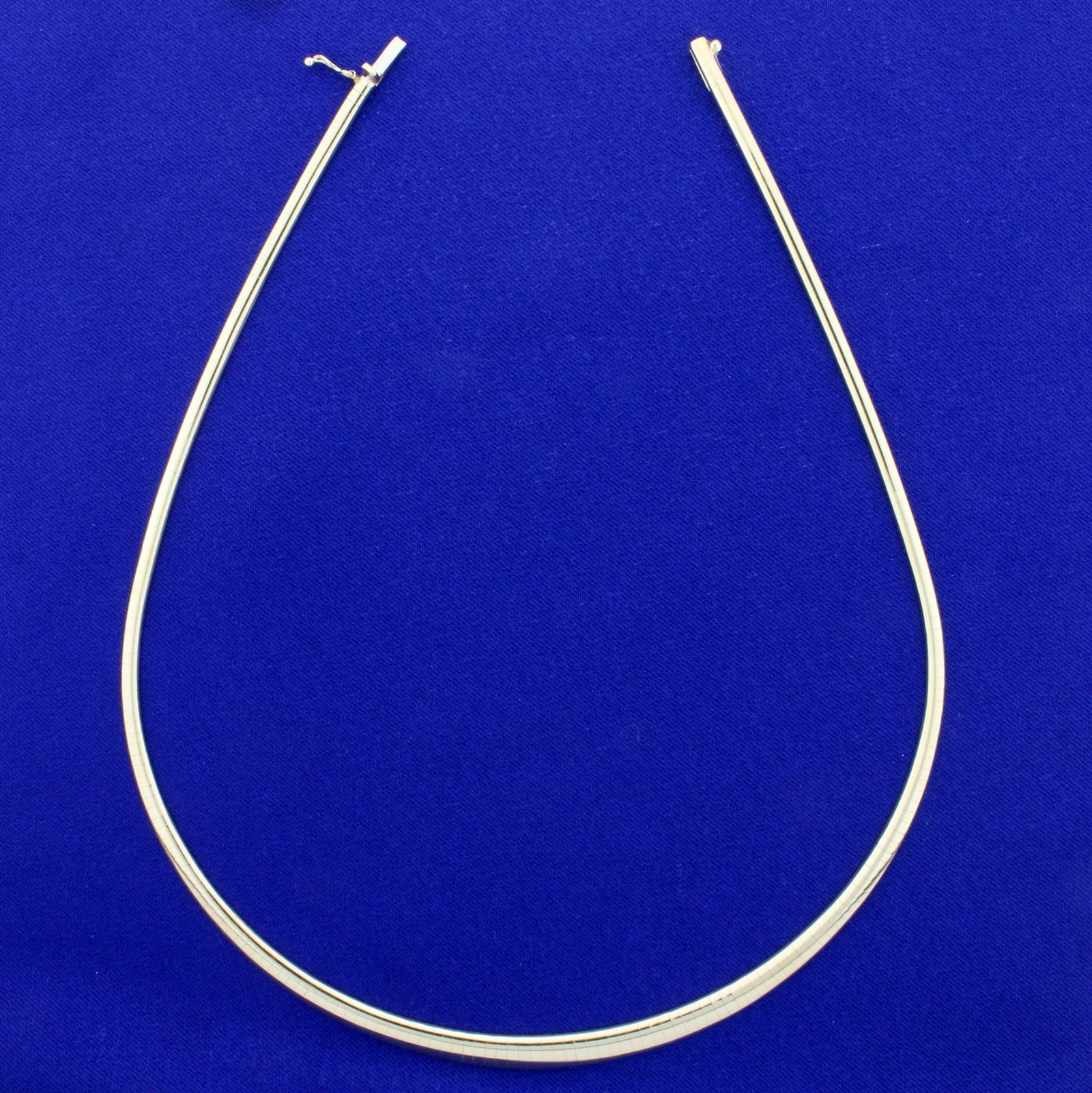 16 Inch Graduated Omega Necklace in 14K Yellow Gold: In 14K Yellow Gold. 16 inches long and 6mm wide, tapers down to 2.8mm. With safety clasp. 17.4g