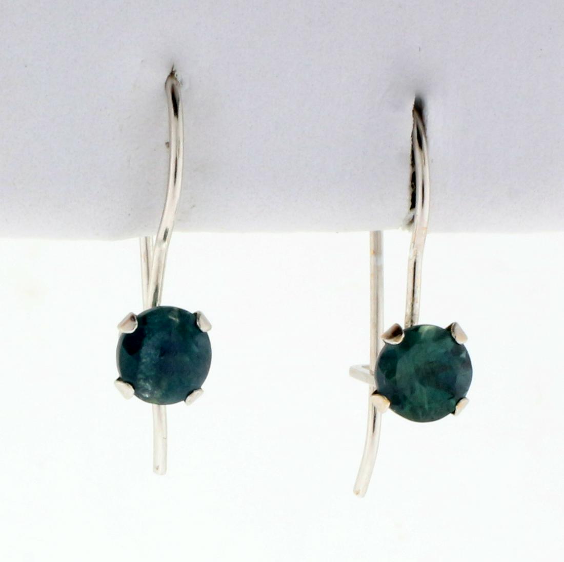 1/2ct TW Natural Alexandrite Earrings in 10K White Gold: In 14K White Gold. 1 inch long, 1/8 inch wide. Each earring contains one high quality natural 4mm Alexandrite gemstone that changes color from green to purple depending on light source. 0.6g.