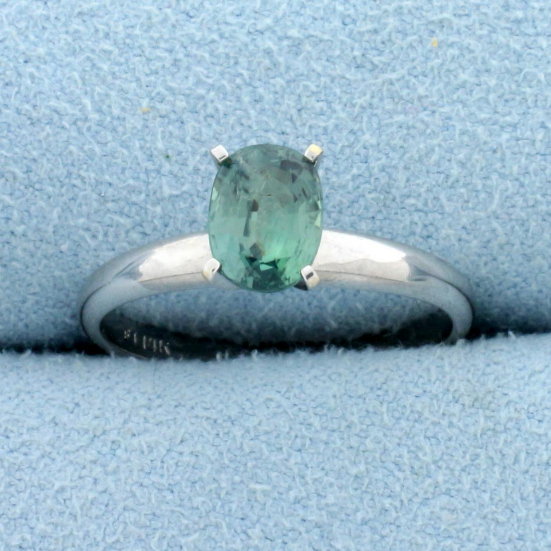 1ct Natural Alexandrite Solitaire Ring in 14K White: In 14K White Gold. Contains one high quality natural 7 x 5mm oval cut Alexandrite gemstone with color change from bright green to golden color depending on light source. Size 6. 2.2g.