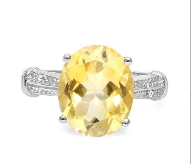 Huge 4.3CT Citrine & Diamond Statement Ring in Sterling: Oval cut 4.31ct citrine gemstone ring with lemon color, accented with .01ctw genuine diamonds. Size 7. Set in platinum over sterling silver, 3.2g.