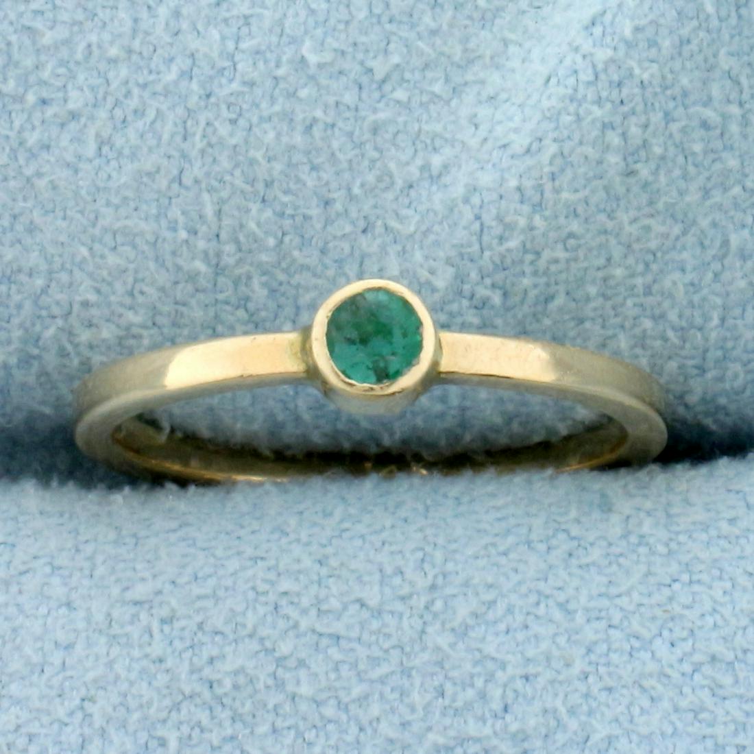 Emerald Solitaire Ring in 14K Yellow Gold: In 14K Yellow Gold. Contains one high quality natural 3mm round cut Emerald gemstone with bright green color. Size 4 1/2. 1.1g.