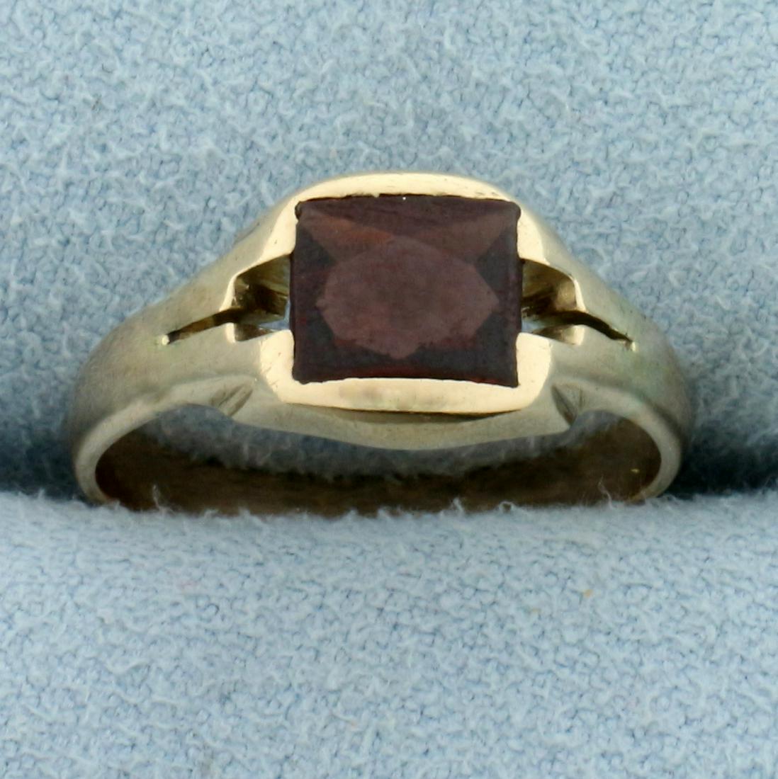 Antique Garnet Ring in 10K Yellow Gold: In10 K Yellow Gold. Contains one high quality natural 7 x 5mm Garnet gemstone with intense red color and excellent clarity. Some abrasion on stone, indicative of age. Size 6. 2.4g.