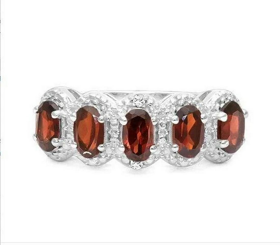 Garnet 5-Stone Halo Ring in Sterling Silver: Ring contains 5-oval cut garnet gemstones, 1.6ctw, accented with .01ctw genuine diamonds. Size 6. Set in platinum over sterling silver, 3.0g.