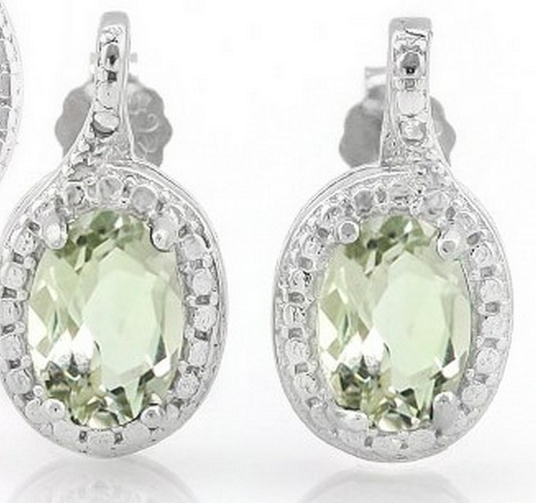 Green Amethyst and Diamond Earrings in Sterling Silver: Contains 2-5x7mm oval cut Green Amethyst gemstones with excellent clarity and green tea color accented with .01ctw genuine diamonds. Measures 9/16" long, set in .925 sterling silver with friction back