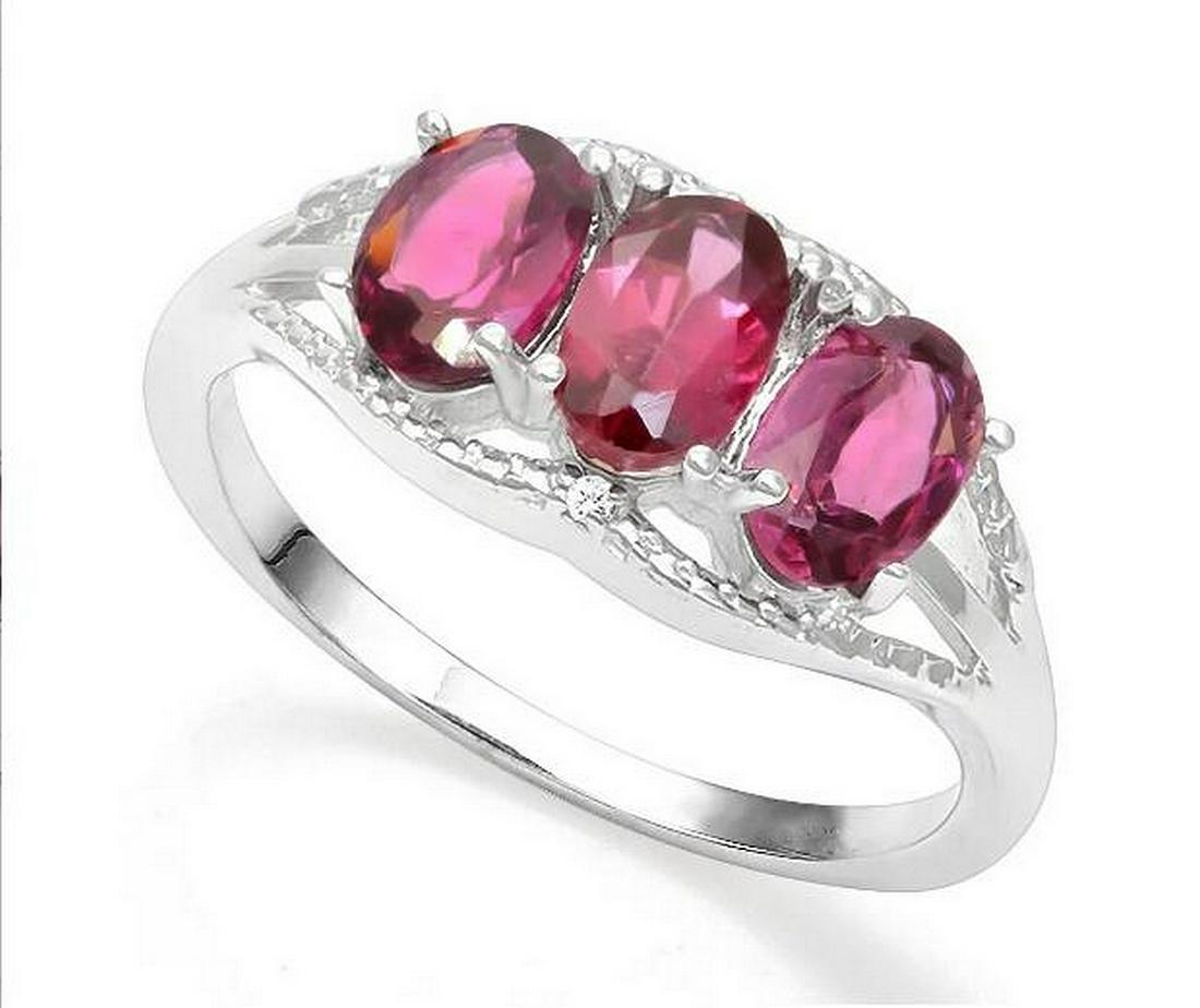 Rhodolite Garnet & Diamond 3-Stone Ring in Sterling: Ring contains 3-oval cut rhodolite garnet gemstones, 1.54ctw, accented with .01ctw genuine diamonds. Size 7. Set in platinum over sterling silver, 2.6g.