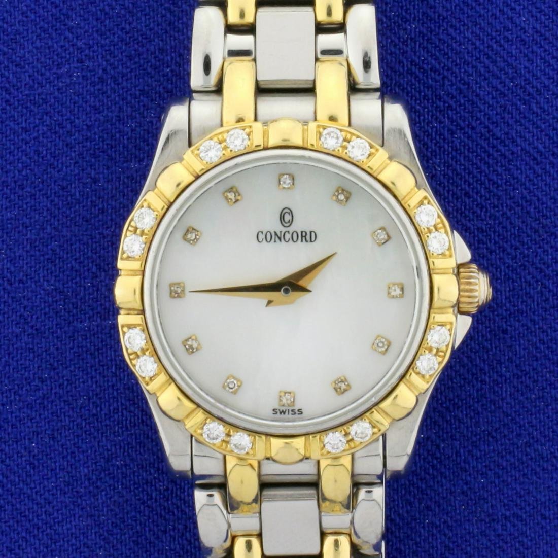 Ladies Concord Saratoga 23mm Diamond Watch with 18k: Band in stainless steel and 18k yellow gold, bezel in 18k yellow gold, case in stainless steel. Watch is in excellent condition with no scratching on crystal and minimal scratching on band. Quartz mov