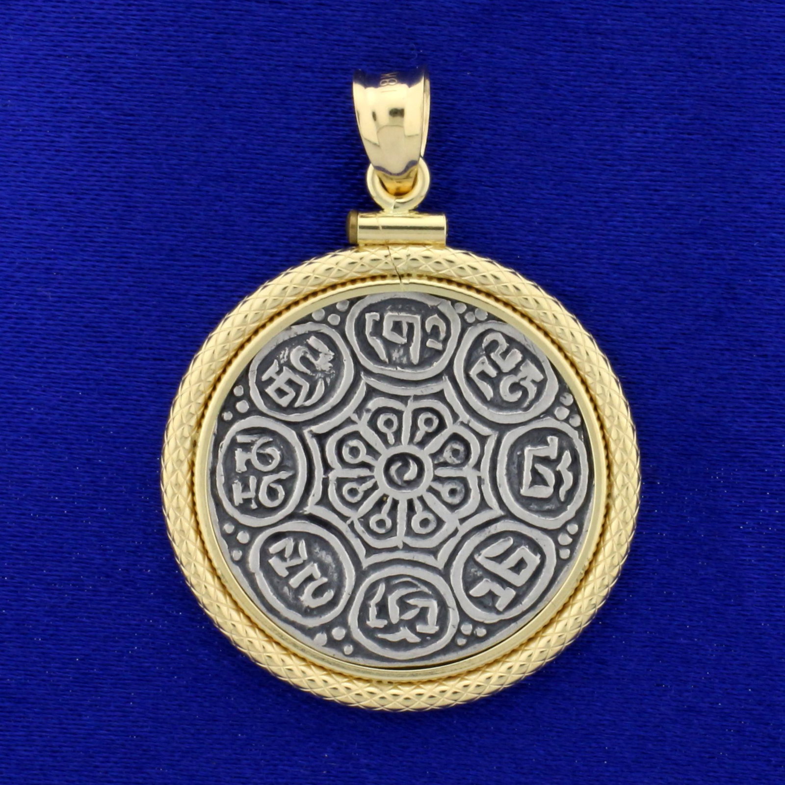 Buddhist Commemorative Coin in 18k Yellow Gold Bezel: Bezel In 18K Yellow Gold. 1 1/2 inches long. Buddhist Commemorative Coin Displaying the 8 Auspicious Symbols. 7.0g.