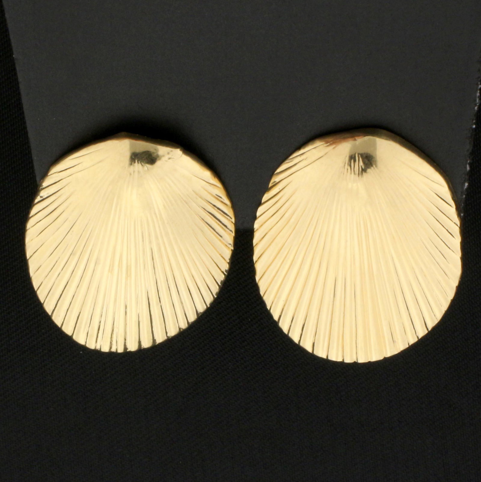 Seashell Earrings in 14K Yellow Gold: In 14K Yellow Gold. 7/8 inch long and 3/4 inch wide. For pierced ears. Do not come with backs. 1.0g