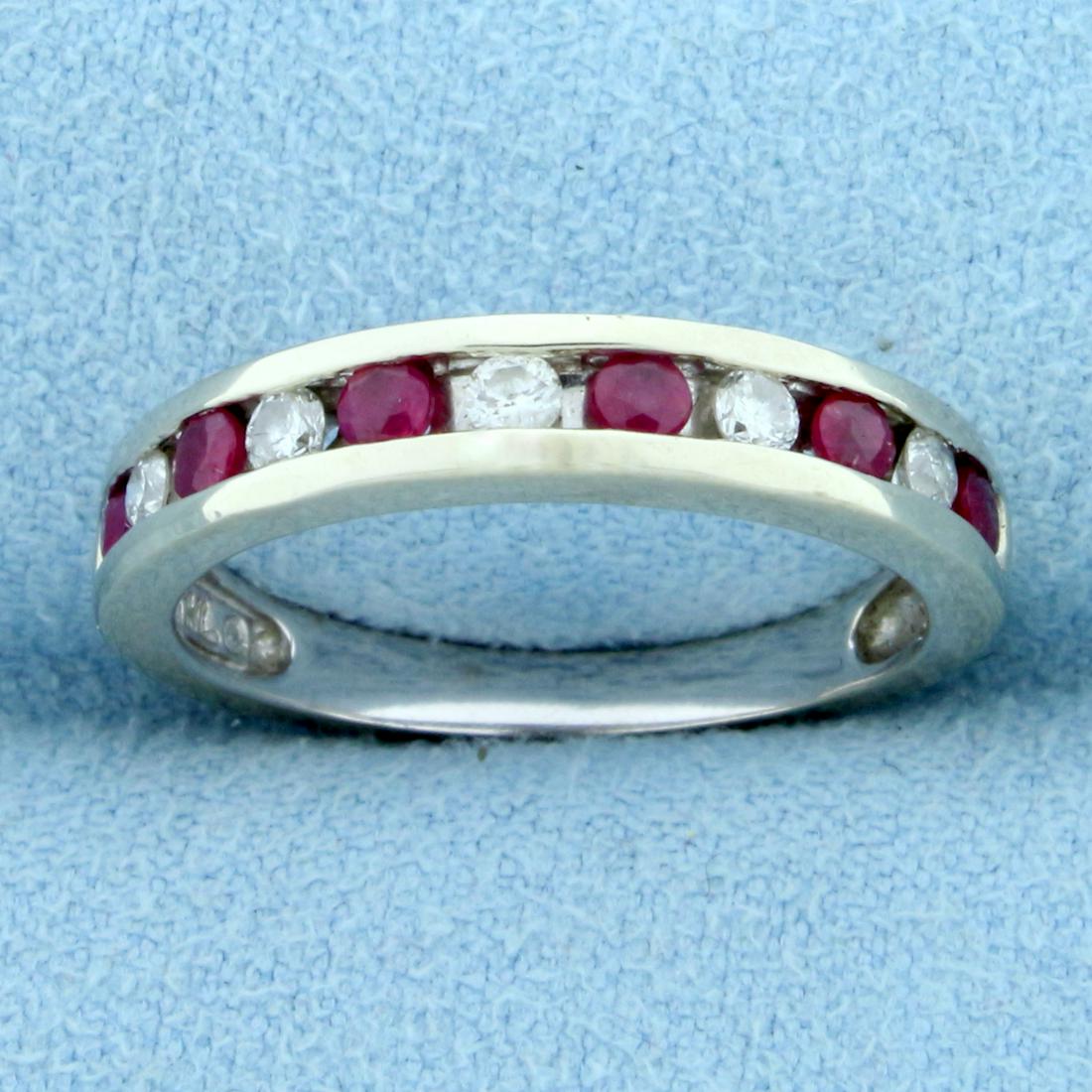 1/3ct TW Ruby and Diamond Channel Set Stacking Band: In 14K White Gold. Contains six 2.5mm round Ruby gemstones with bright red color and excellent clarity. Also contains five high quality .03ct round cut Diamonds, SI clarity/H color. Size 7 1/4. 3.4g.