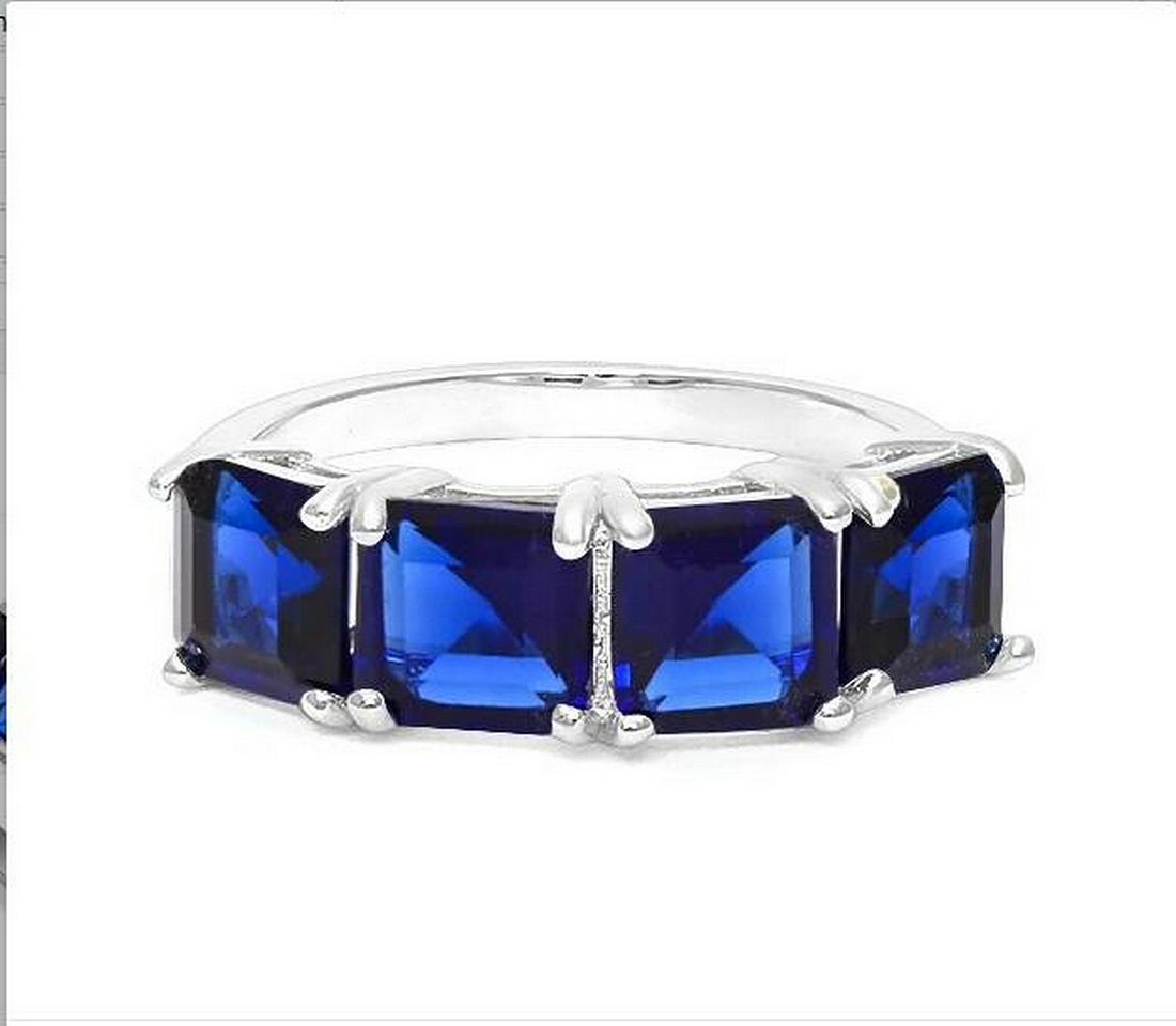 Large Sapphire Line Stack Ring in Sterling Silver: Square step-cut genuine blue sapphire gemstones, lab created, with vivid blue color, are prong set in a stackable ring mounting. Size 8. Set in platinum over sterling silver, 3.3g.