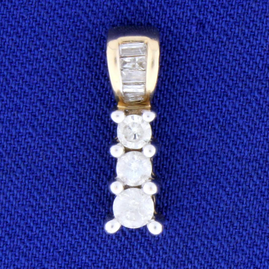 1/2ct TW Diamond Gold Pendant in 10k Yellow Gold: In 10k yellow gold. Contains three round high quality round brilliant diamonds - one .15 ct and two .1 ct.. Also contains five high quality baguette diamonds. All diamonds, H color/I clarity. 5/8" lon