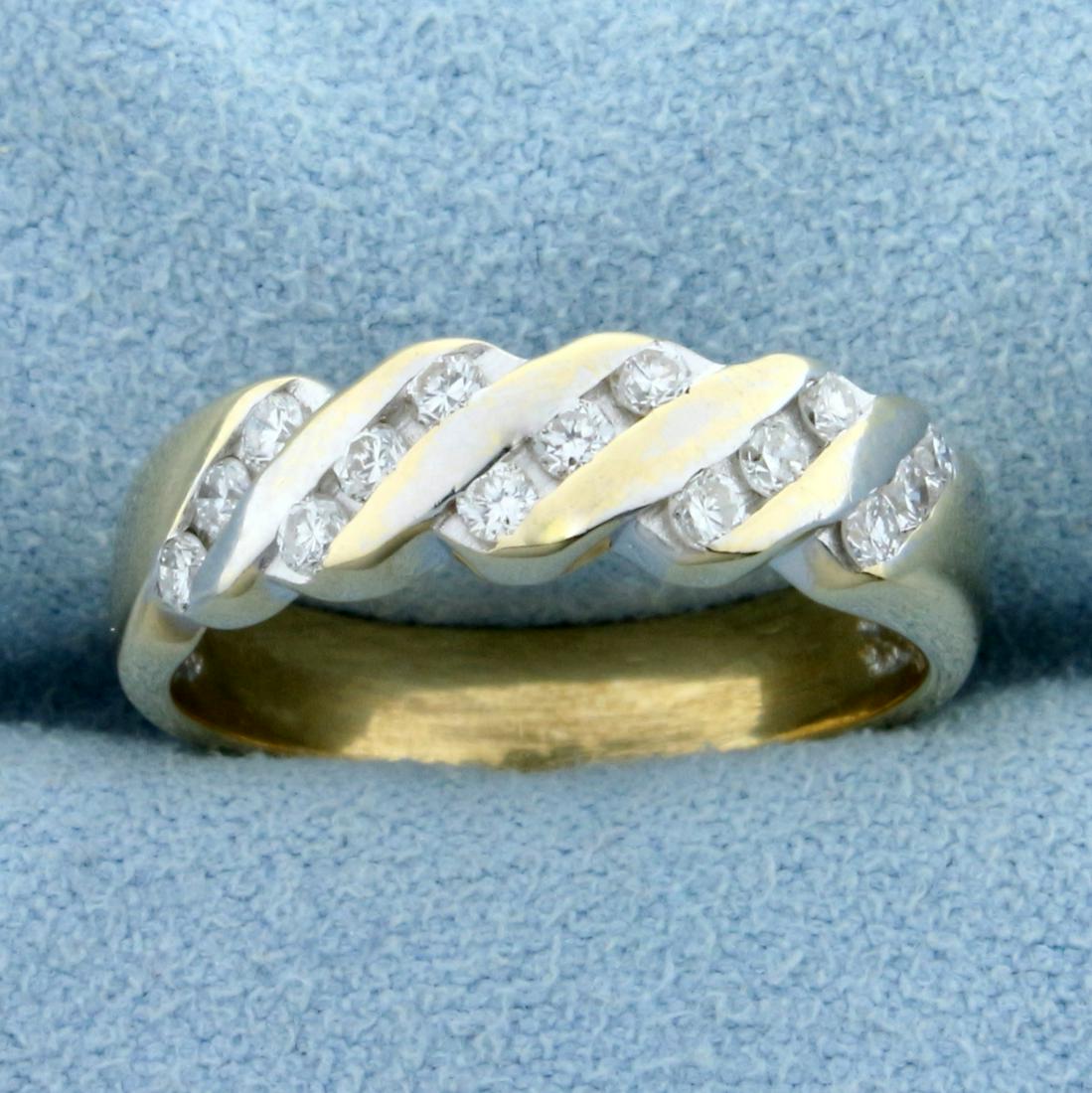 Unique Channel Set Diamond Anniversary or Wedding Ring: In 14K Yellow Gold. Contains fifteen high quality .01ct Diamonds, SI clarity/H color. Size 6 1/2. 4.4g.