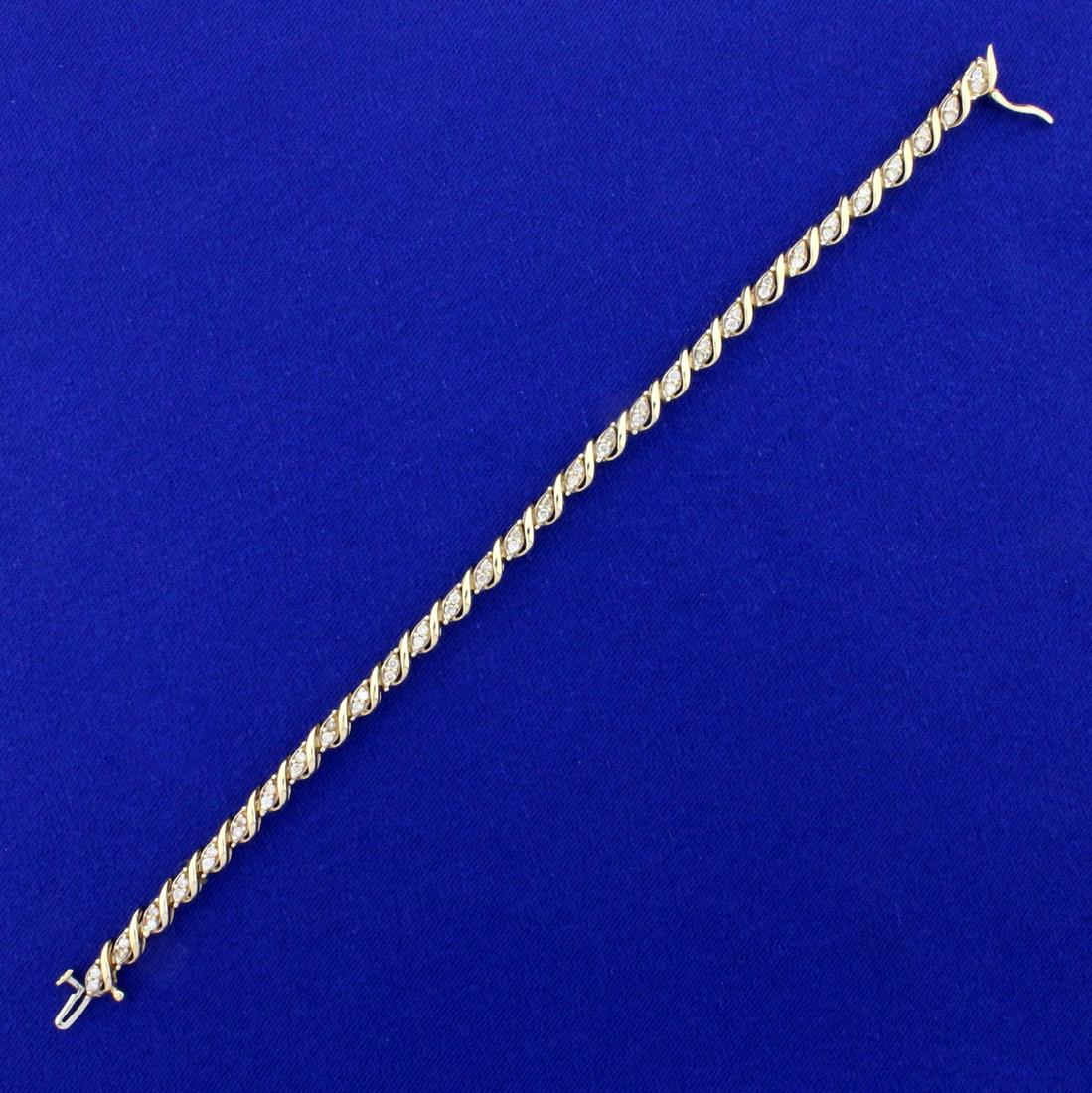 1ct TW Diamond Tennis Bracelet in 14K Yellow Gold: In 14K Yellow Gold. Contains sixty high quality diamonds, 1ct TW, I color/I clarity. 7 1/4 inches long and 4.1mm wide. 10.8g