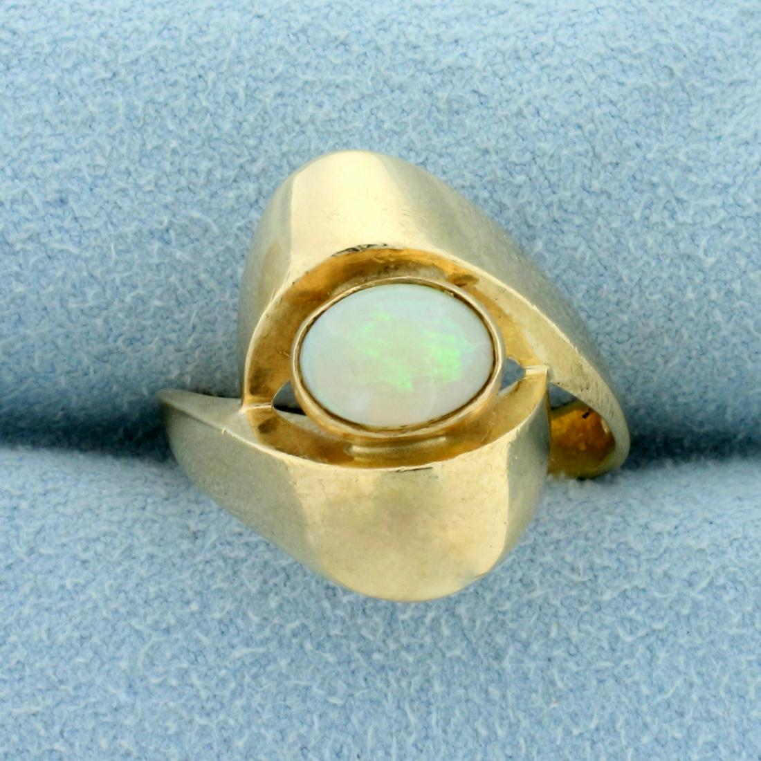 Designer Opal Solitaire Ring in 14K Yellow Gold: In 14K Yellow Gold. Contains one high quality natural 8x6mm oval Opal gemstone with high play of color with flashes of green, purple, and orange. Size 7 3/4. 5.0g