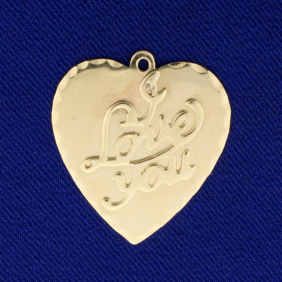 Love You Pendant in 14K Yellow Gold: In 14K Yellow Gold. Blank back to inscribe name or date. 1 inch long. 3.4g.