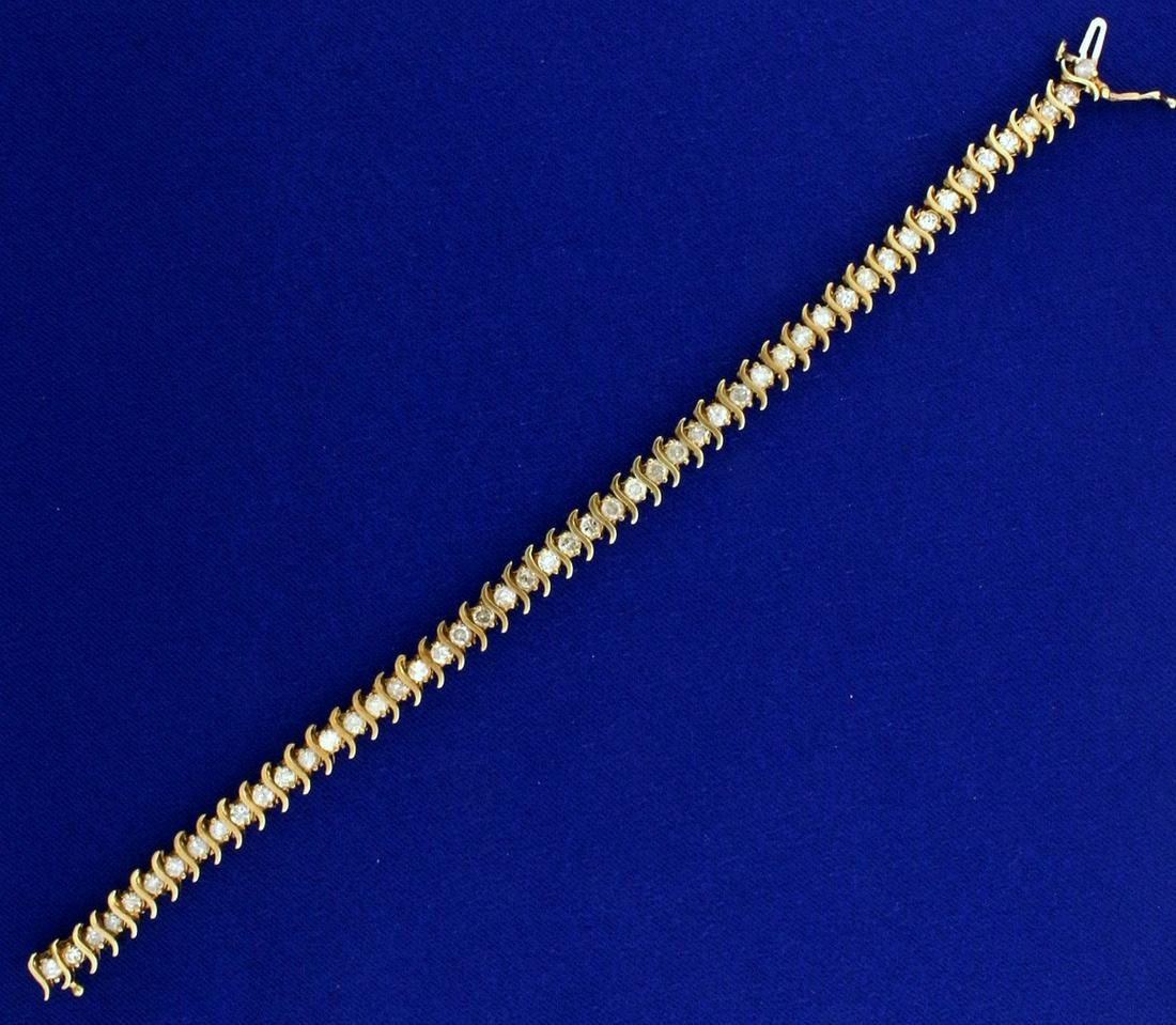 4ct TW Diamond Tennis Bracelet in 10k Yellow Gold: In 10k yellow gold, containing I color/I clarity diamonds. 7 1/2 inches long with safety clasp. 12.5g.