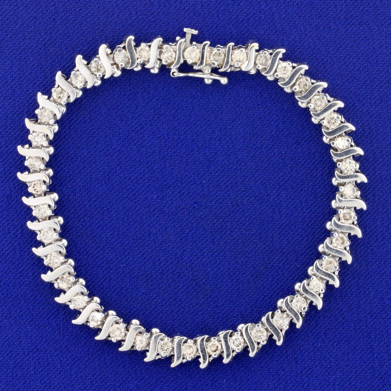 2ct TW Champagne Diamond Tennis Bracelet in 14k White: in 14K White Gold. Contains 40 high quality .05ct Champagne Diamonds with warm color. 6 3/4 inches long, 6mm wide. Safety clasp. 13.8g.