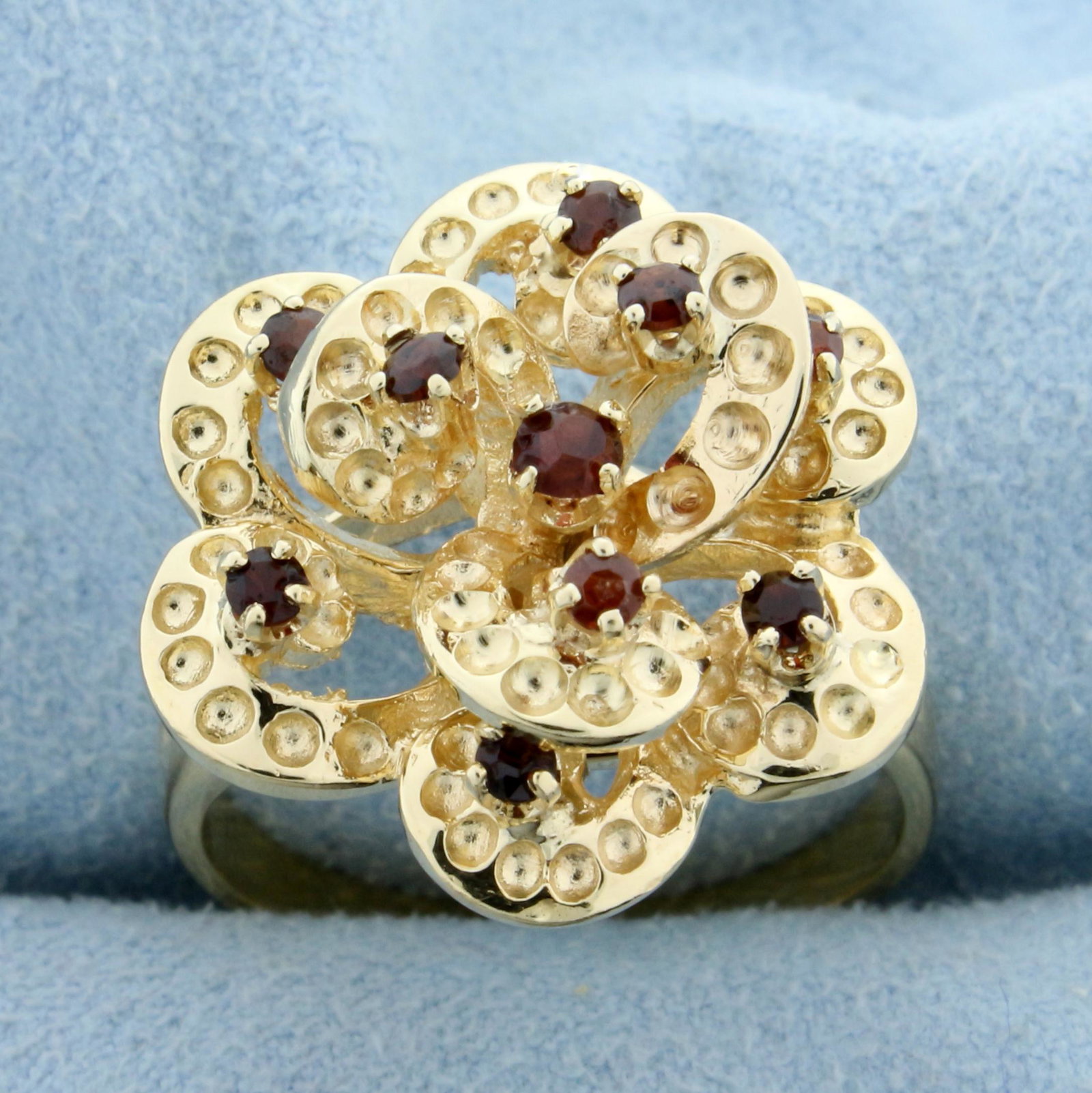 Garnet Flower Ring in 14K Yellow Gold: In 14K Yellow Gold. Contains nine high quality natural 2mm round cut Garnet gemstones and one high quality natural 2.75mm round cut Garnet. Size 10. 8.8g