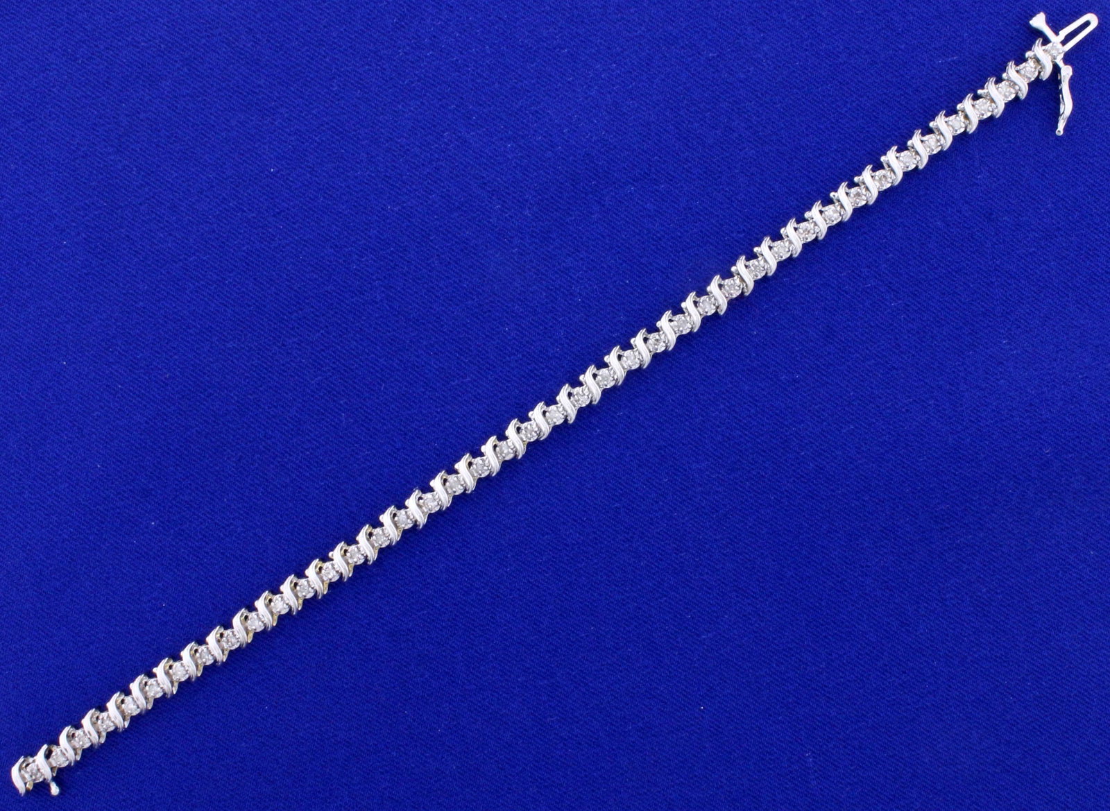 1/2ct TW Diamond Tennis Bracelet in 14k White Gold: In 14k white gold. Contains 1/2 ct TW of high quality diamonds, I color/I clarity. 7 1/4" long, with safely clasp. 8.3g.