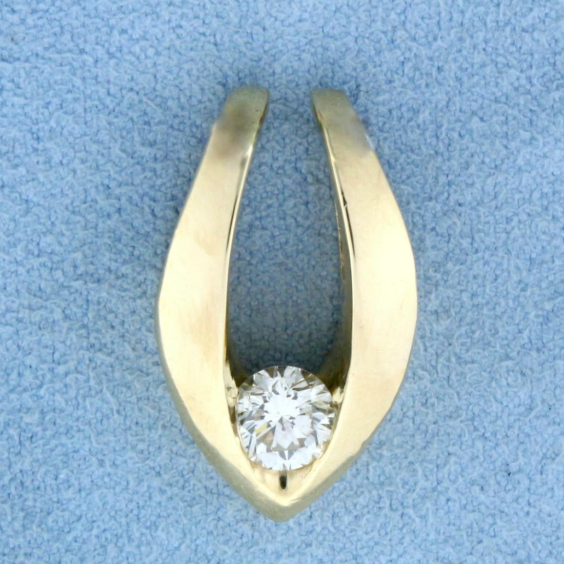 2/3ct Diamond Solitaire Slide in 14K Yellow Gold: In 14K Yellow Gold. Contains one high quality .66ct round brilliant Diamond, SI1 clarity/K color, excellent cut for lots of sparkle. 1 inch long, 1/2 inch wide. 7.5g.